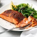 Fully cooked air fryer salmon with veggie side.