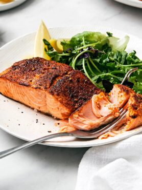 Fully cooked air fryer salmon with veggie side.