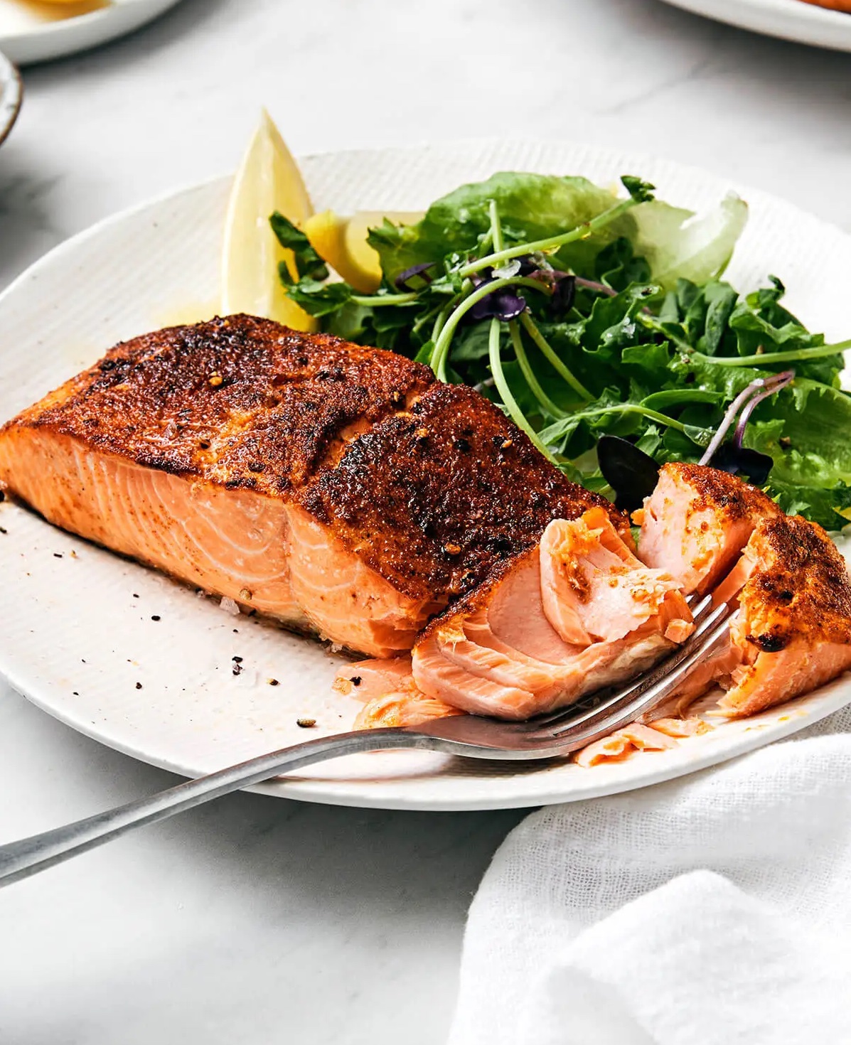 Fully cooked air fryer salmon with veggie side.