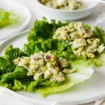 Delicious avocado egg salad over lettuce leaves.