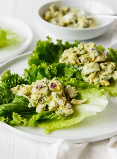 Delicious avocado egg salad over lettuce leaves.