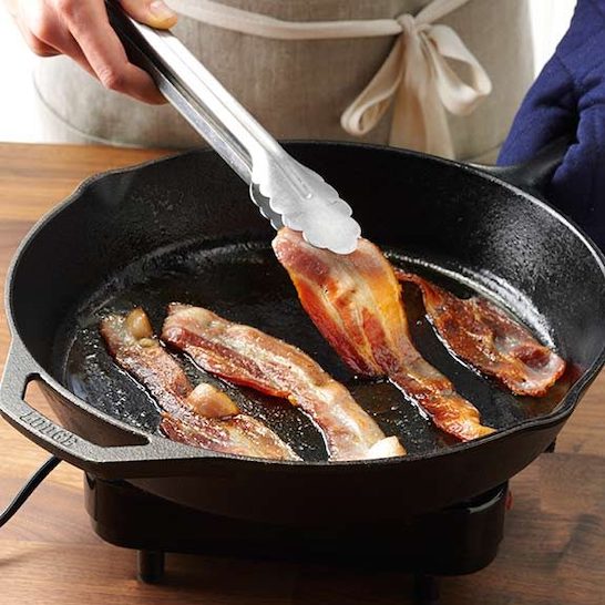 Cooking bacon slowly.