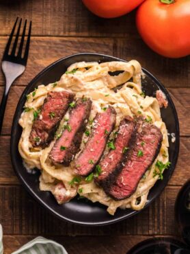 Steak fettuccine alfredo dish ready to serve and eat.