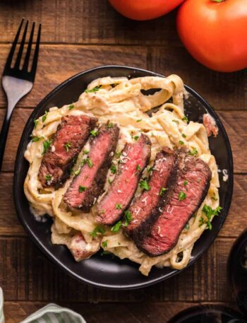 Steak fettuccine alfredo dish ready to serve and eat.