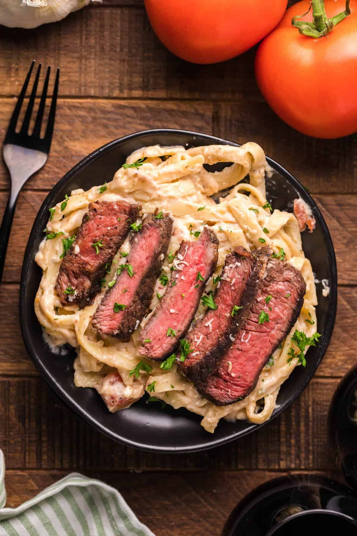 Steak fettuccine alfredo dish ready to serve and eat.