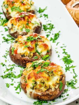 Stuffed portobello mushrooms served on plate.