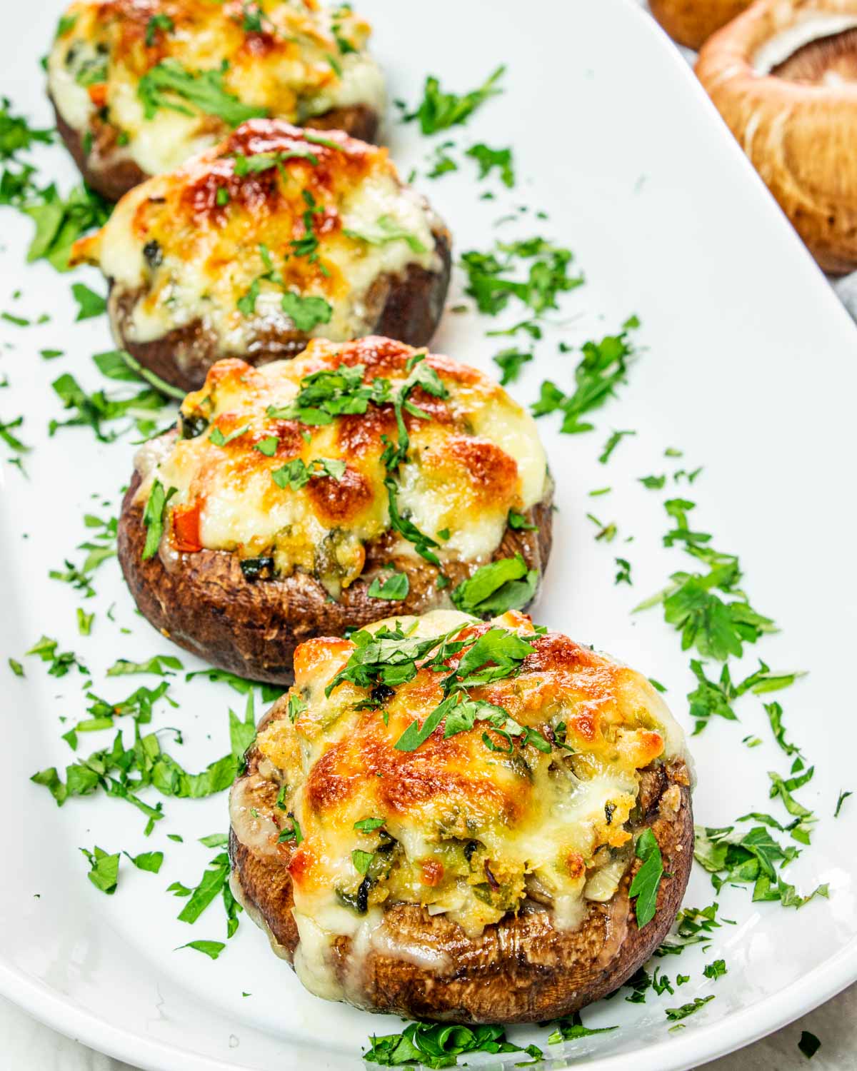 Stuffed portobello mushrooms served on plate.