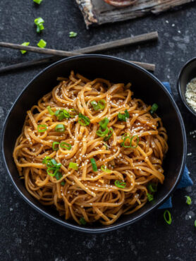 Instant Pot Garlic Noodles served with toppings.