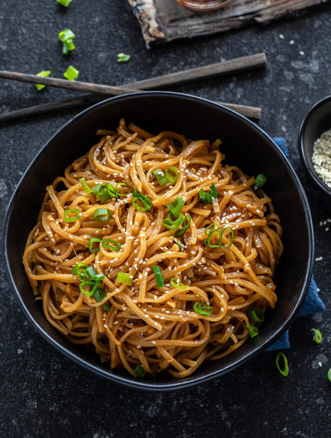 Instant Pot Garlic Noodles served with toppings.